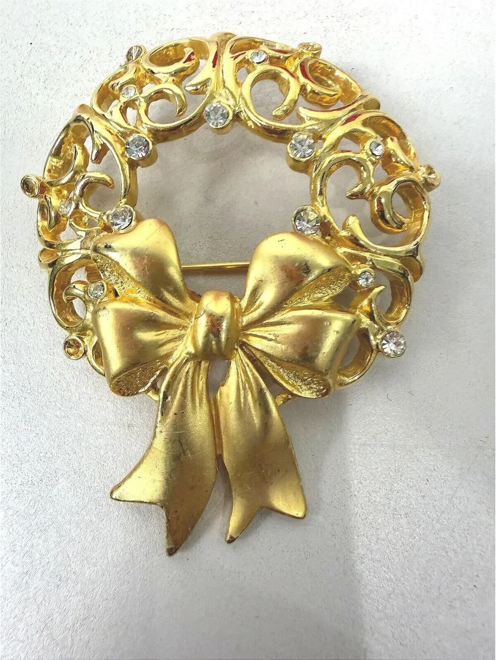 Vintage JJ Gold Tone Wreath Brooch with Bow and Rhinestones